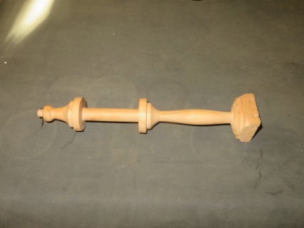 The completed brochette. A bobbin or shuttle used in handweaving or embroidery